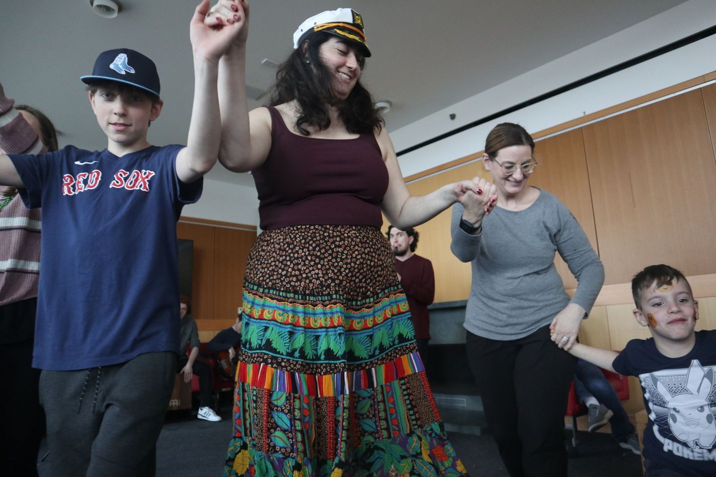 A group of people are dancing together in a room.