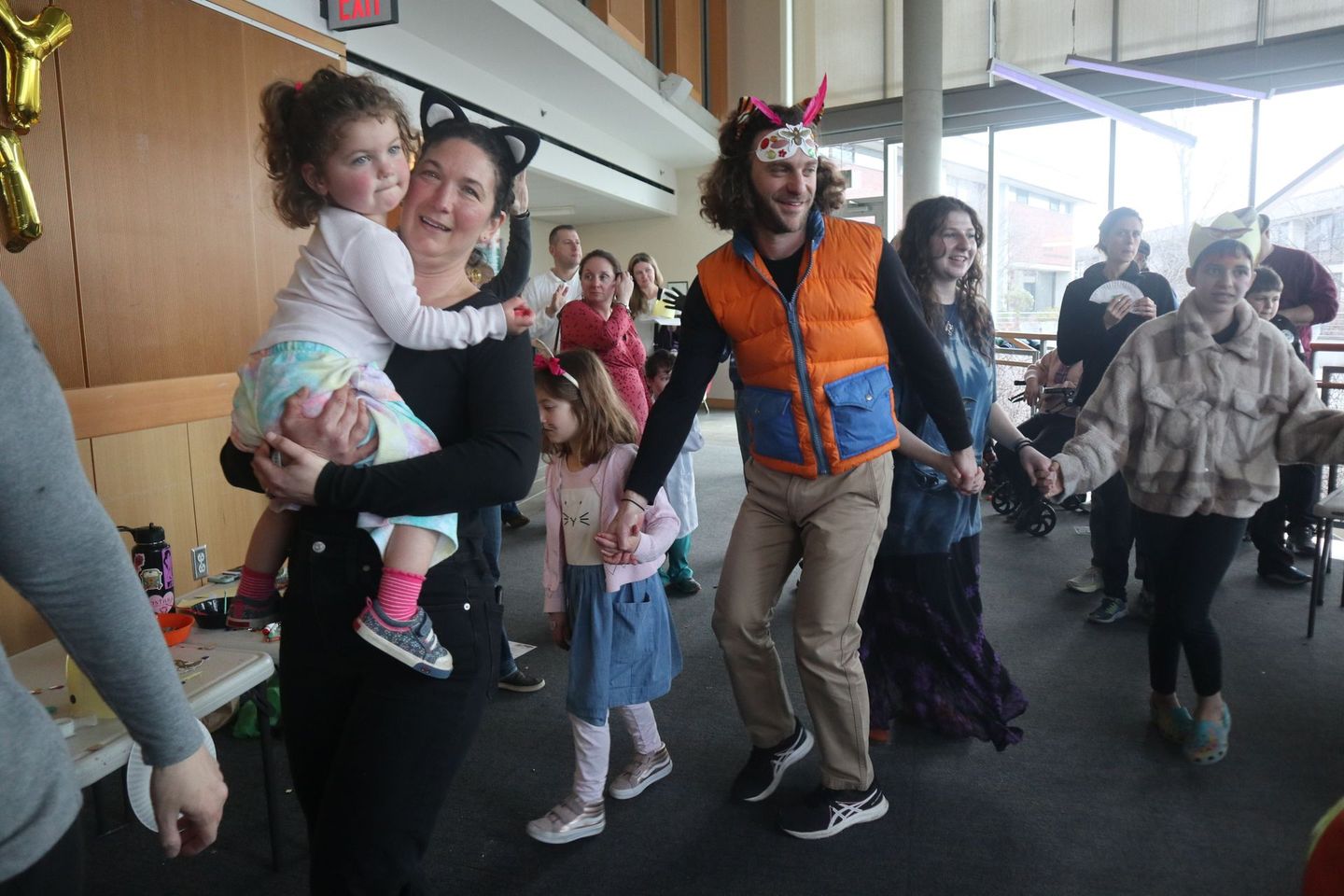 A group of people are dancing together in a room.