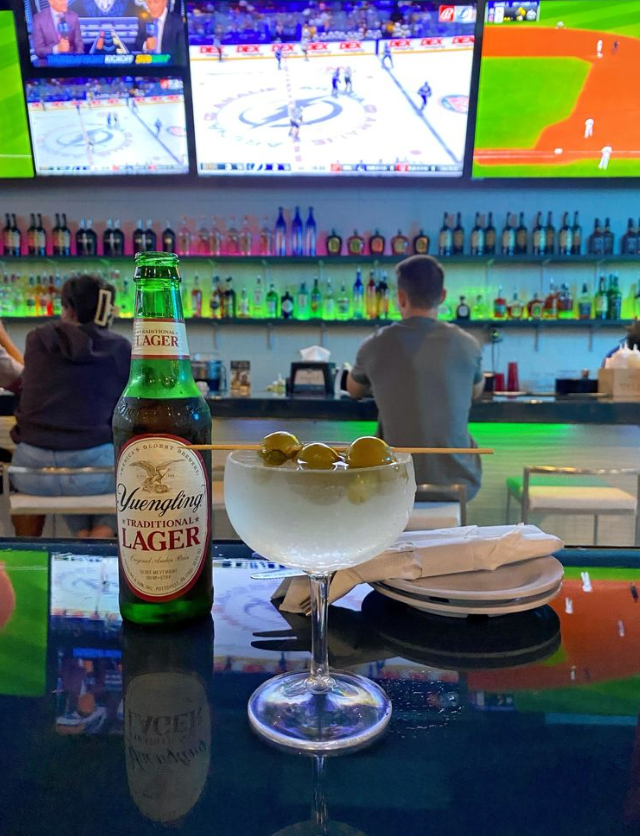 A white plate topped with biscuits , jam , butter and dipping sauce.