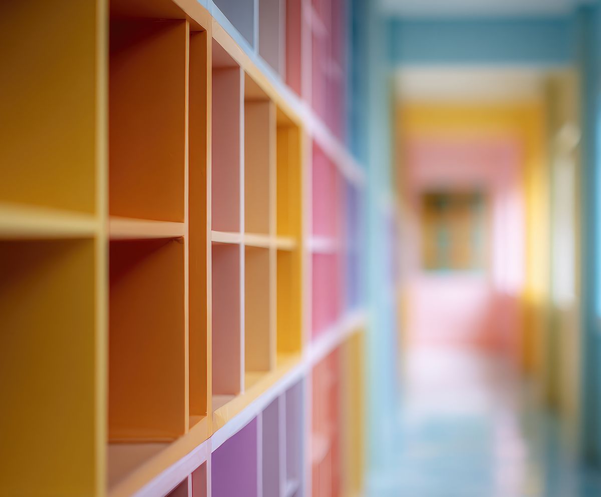 Colorful cubbies in a school hallway, with the hallway blurred in the background.