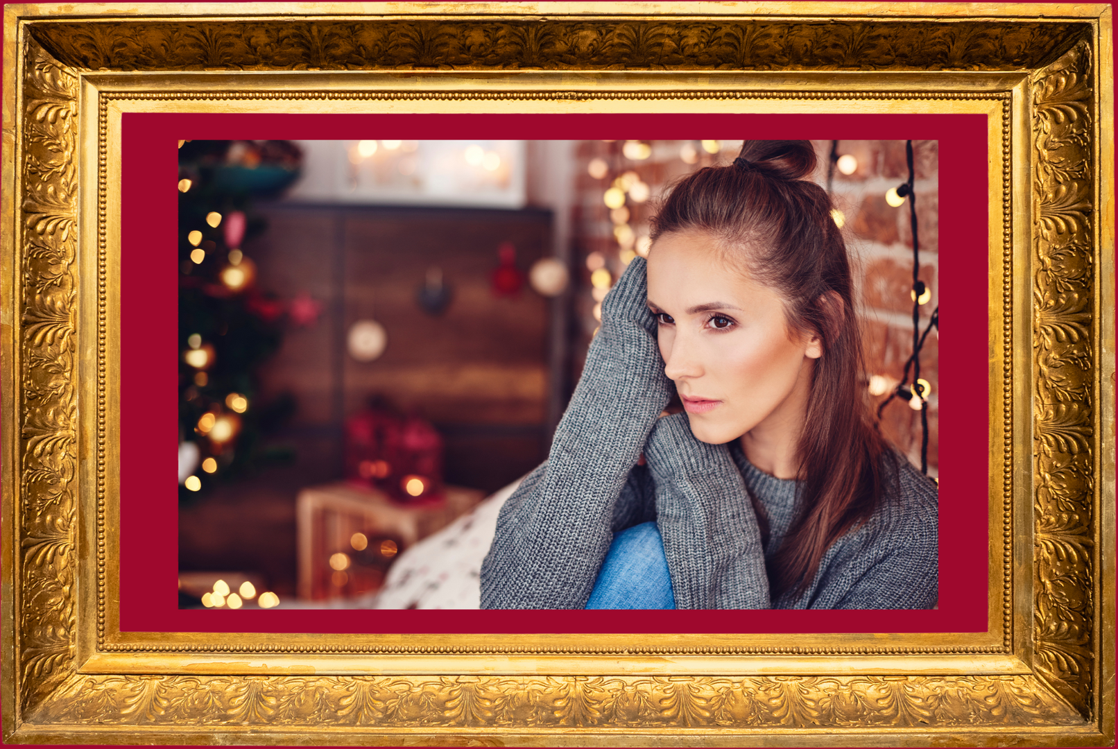 A woman is depressed sitting on a couch during the holidays in a picture frame.