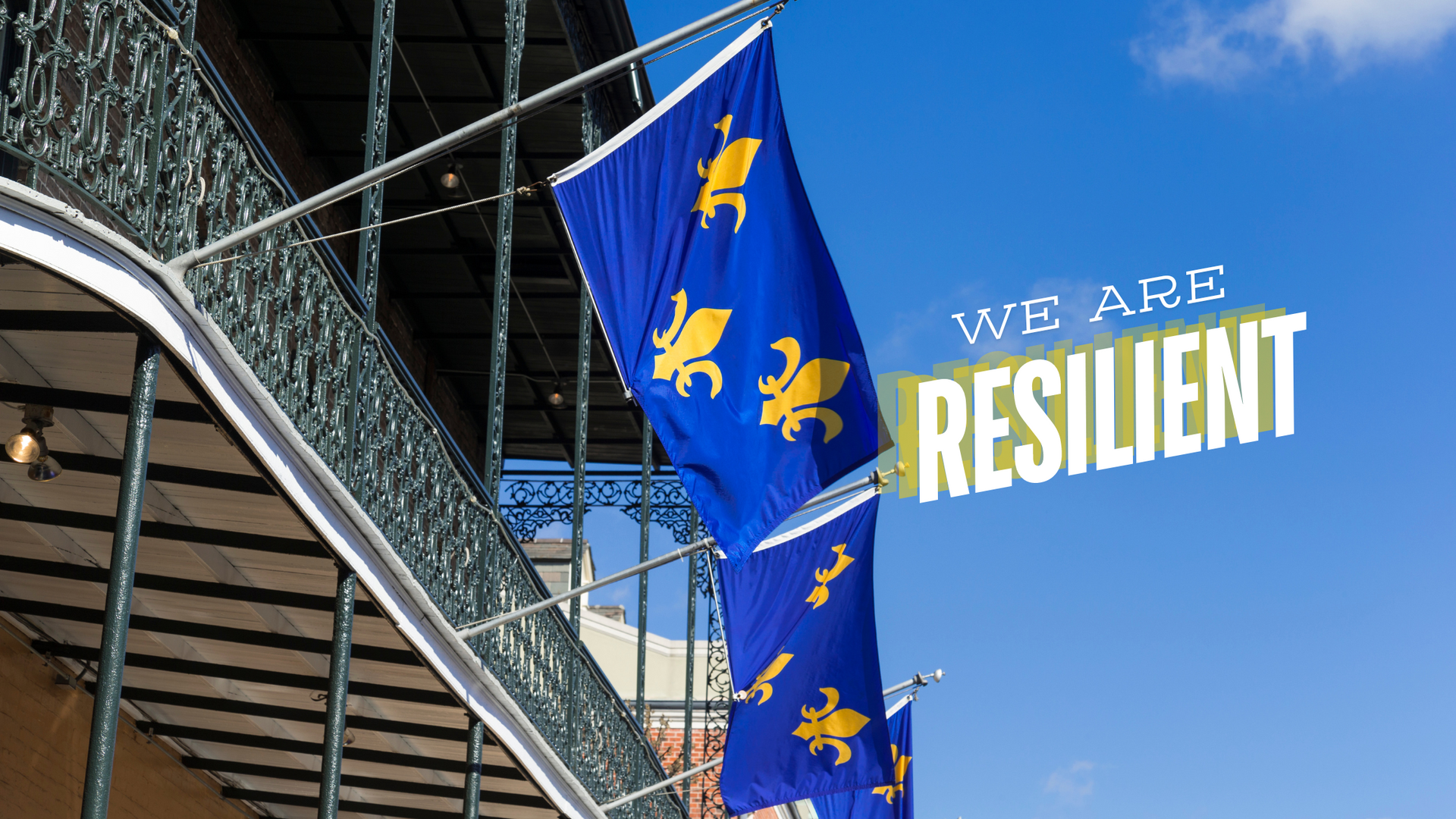 New Orleans building with fleur-de-lis flag waving proudly in the wind, symbolizing resilience.