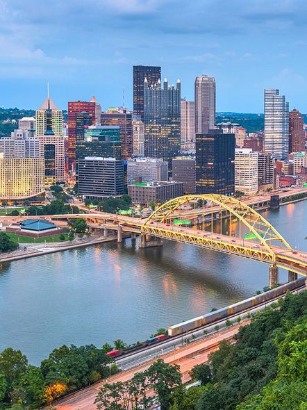 An aerial view of a city with a bridge over a river.