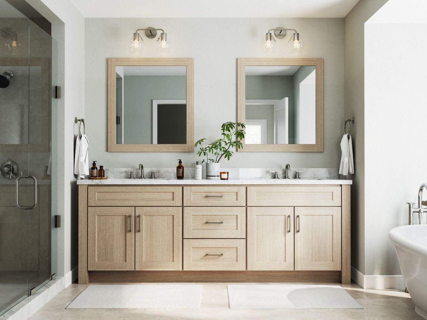 A modern bathroom with double vanity, light wood cabinets, and large mirrors; neutral color scheme.