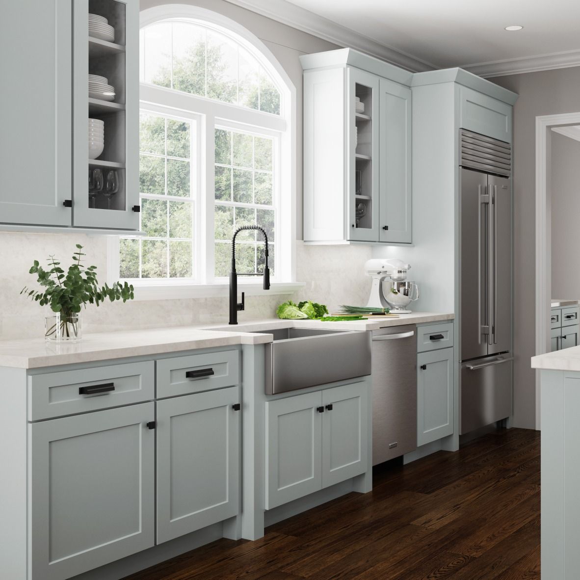 Light blue kitchen with stainless steel appliances and dark wood floor.