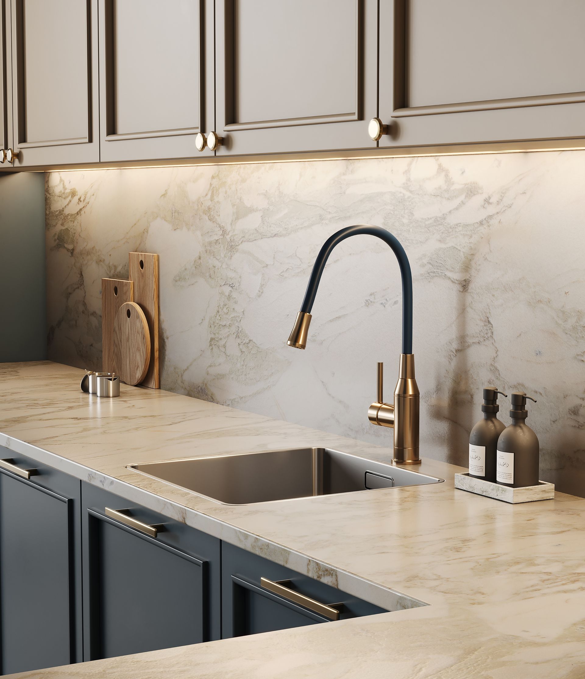 Kitchen sink with gold faucet, marble countertop, dark blue cabinets, and wooden cutting boards.