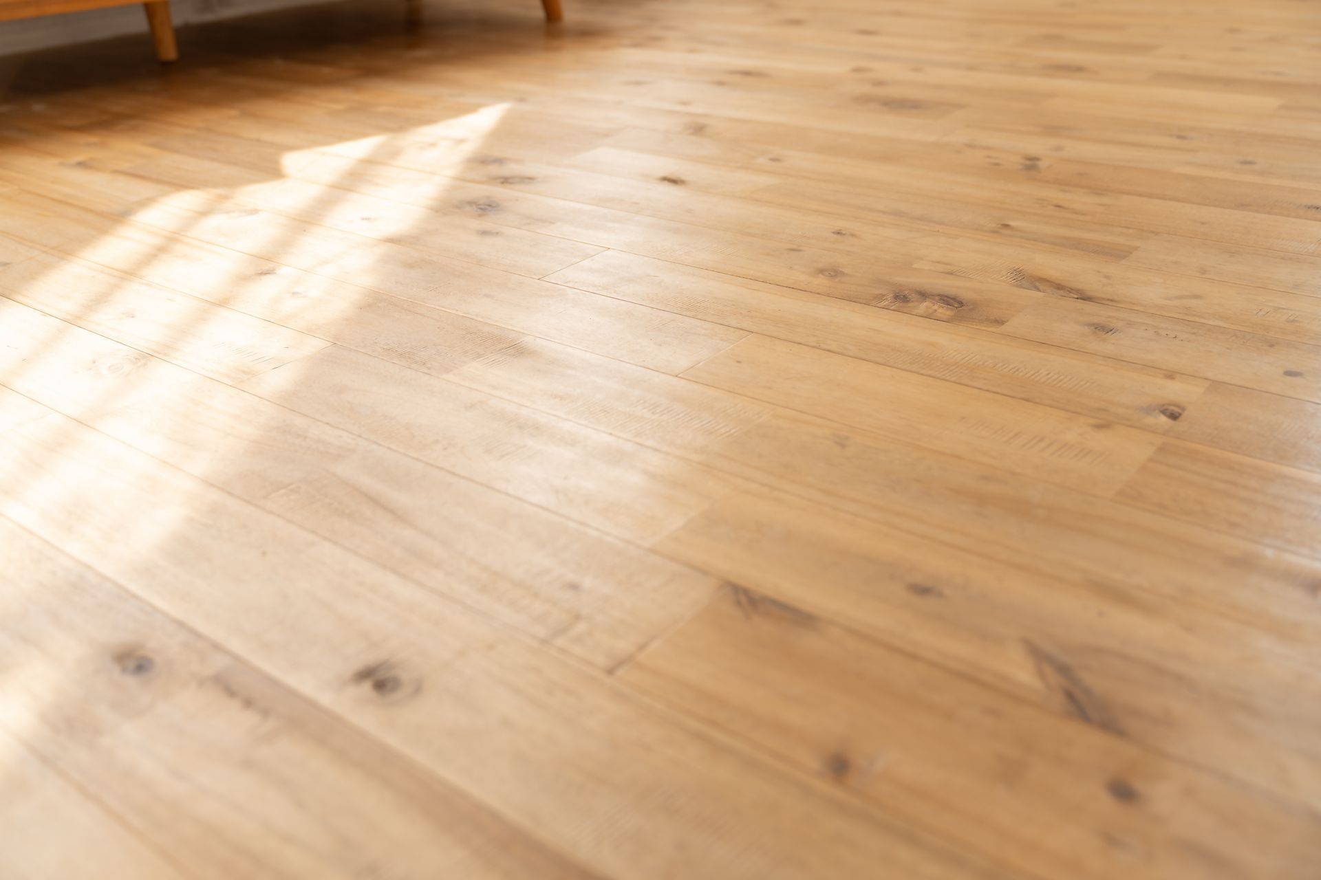 Light wood floor with sun highlights.