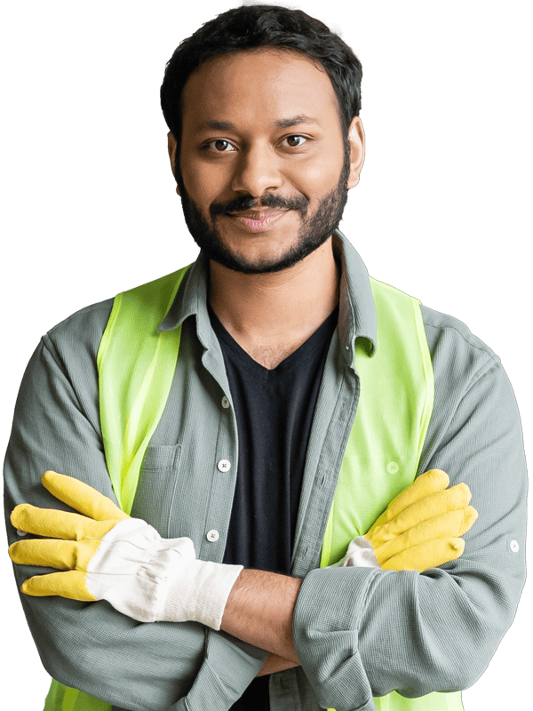 A man wearing a safety vest and yellow gloves is standing with his arms crossed.
