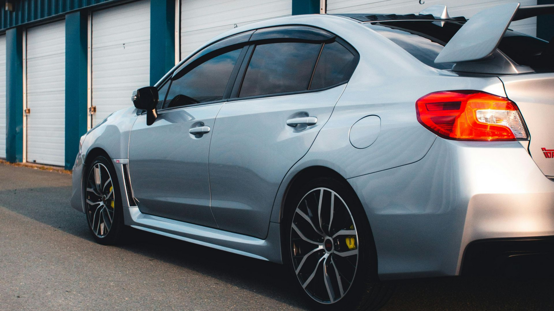 Subaru WRX receiving professional ceramic window tint installation with sleek dark tinted windows, sporty styling, and freshly detailed exterior finish.