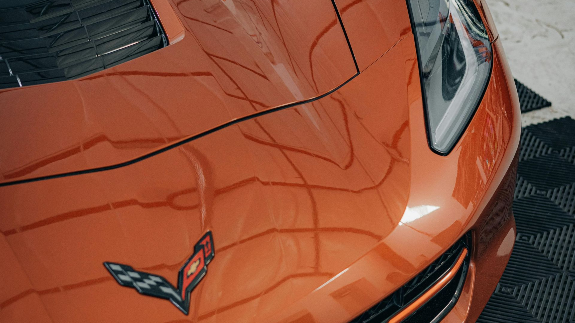Chevy Corvette receiving professional paint correction for a deep, glossy finish. Chevy Corvette receiving professional paint correction to remove swirl marks and restore deep gloss and paint clarity.