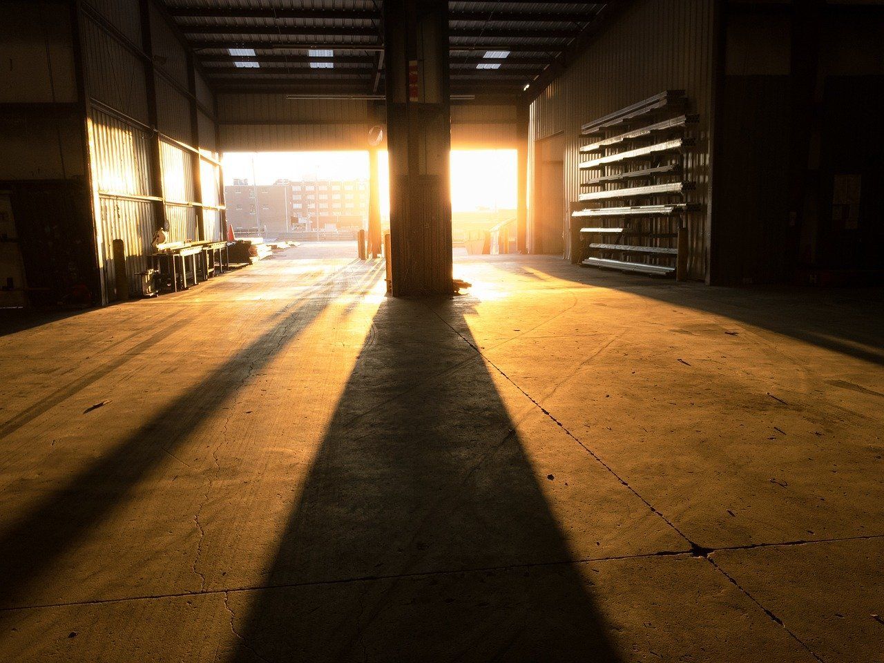 Large cleaned out warehouse with sun shining in