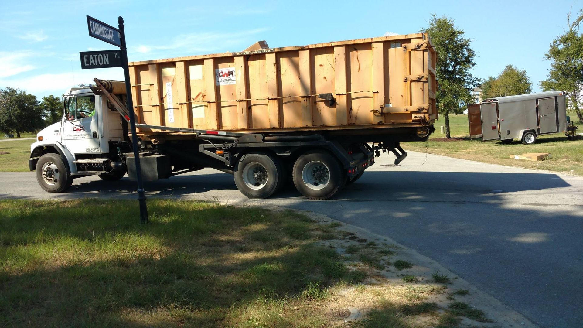 A dump truck is parked on the side of the road