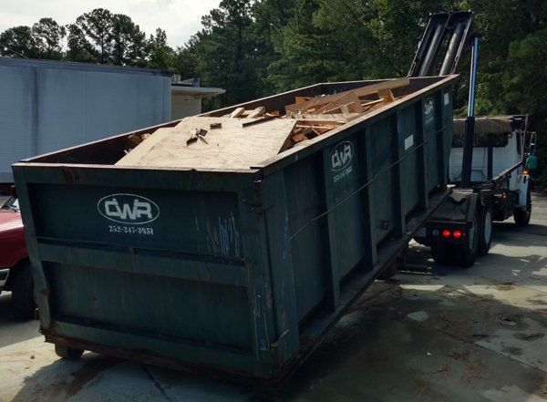 A dumpster with the word cmr on it