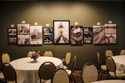 An artist 's impression of a hotel lobby with a couch , chairs , and plants.