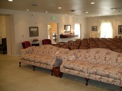 A church with rows of wooden benches and a podium