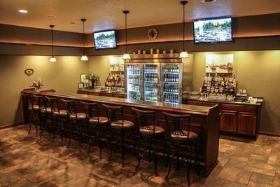 The front door of a house with a porch and plants in front of it.