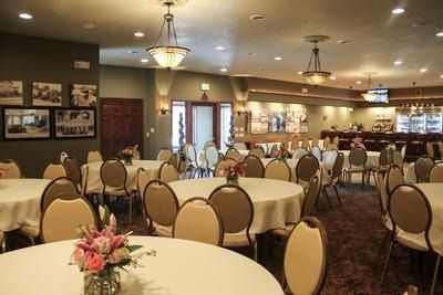 A living room with a couch , chairs , and a coffin.
