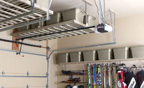 A garage with a ceiling shelf and a garage door opener.