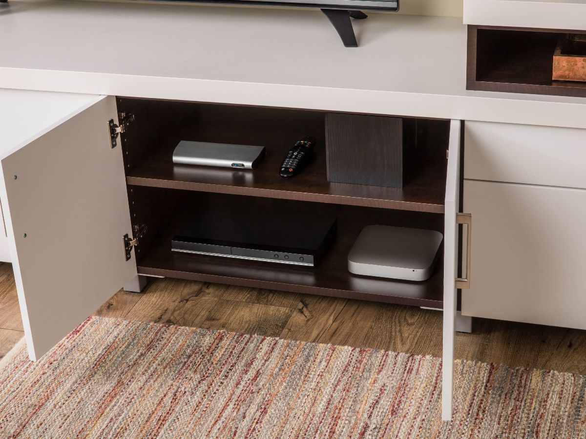 A white entertainment center with the doors open and a tv on top of it.