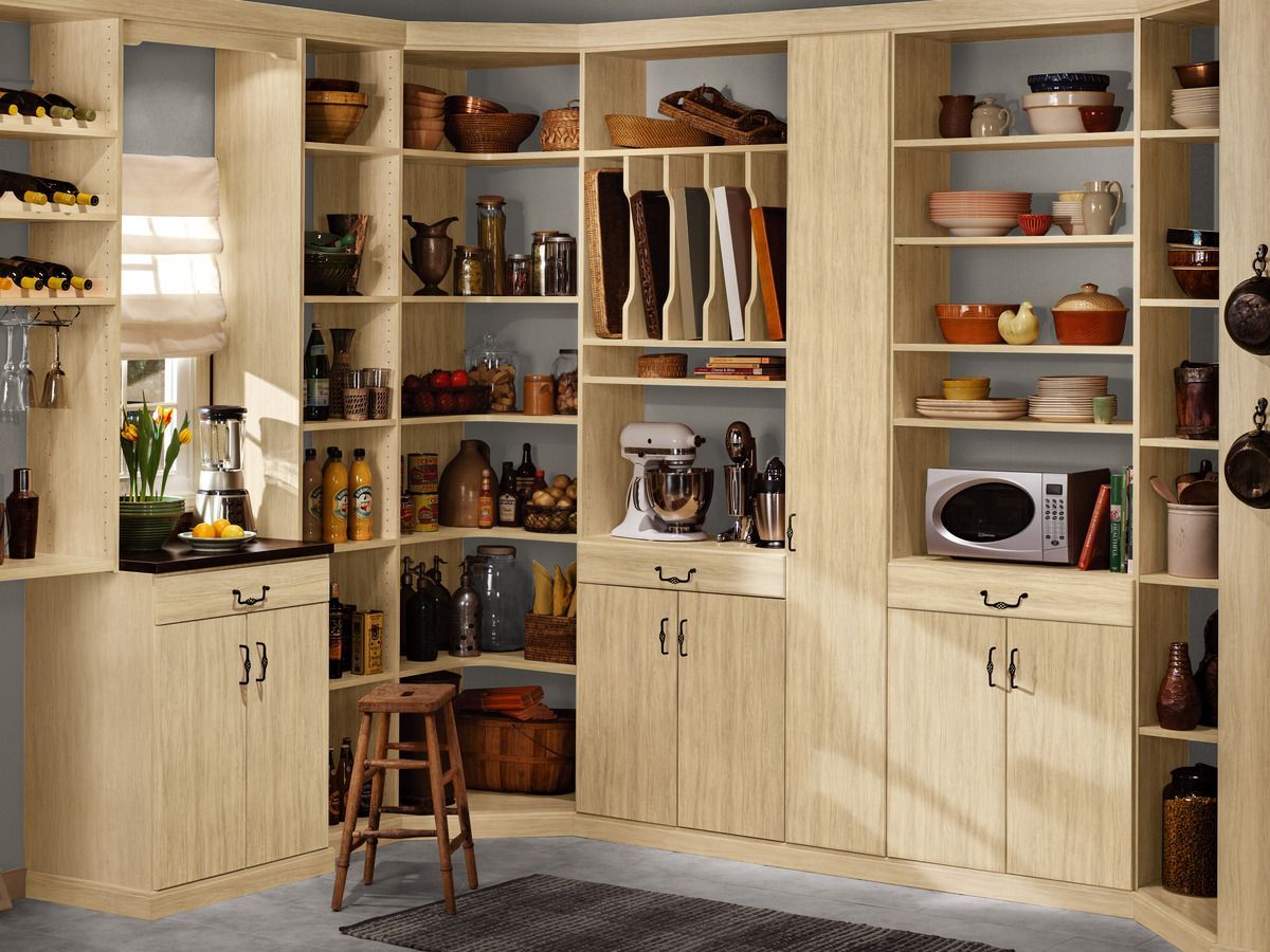 A kitchen with lots of shelves and cabinets and a microwave