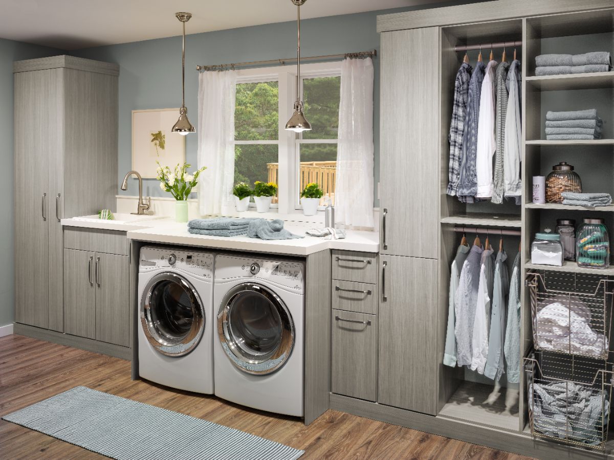 A laundry room with a washer and dryer and a sink.