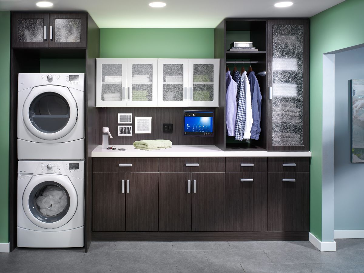 A laundry room with a washer and dryer stacked on top of each other