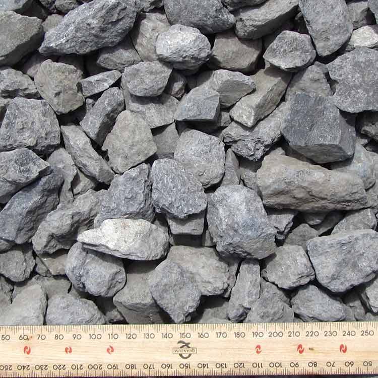 Pile of Gray, Irregularly Shaped Rocks With a Ruler at the Bottom — Kuranda Landscape Supplies in Kuranda, QLD