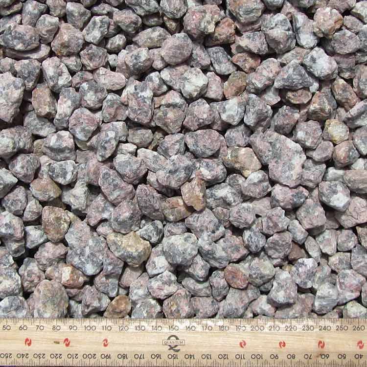 Close-up of Small, Reddish-brown Gravel Stones With a Wooden Ruler for Scale — Kuranda Landscape Supplies in Kuranda, QLD