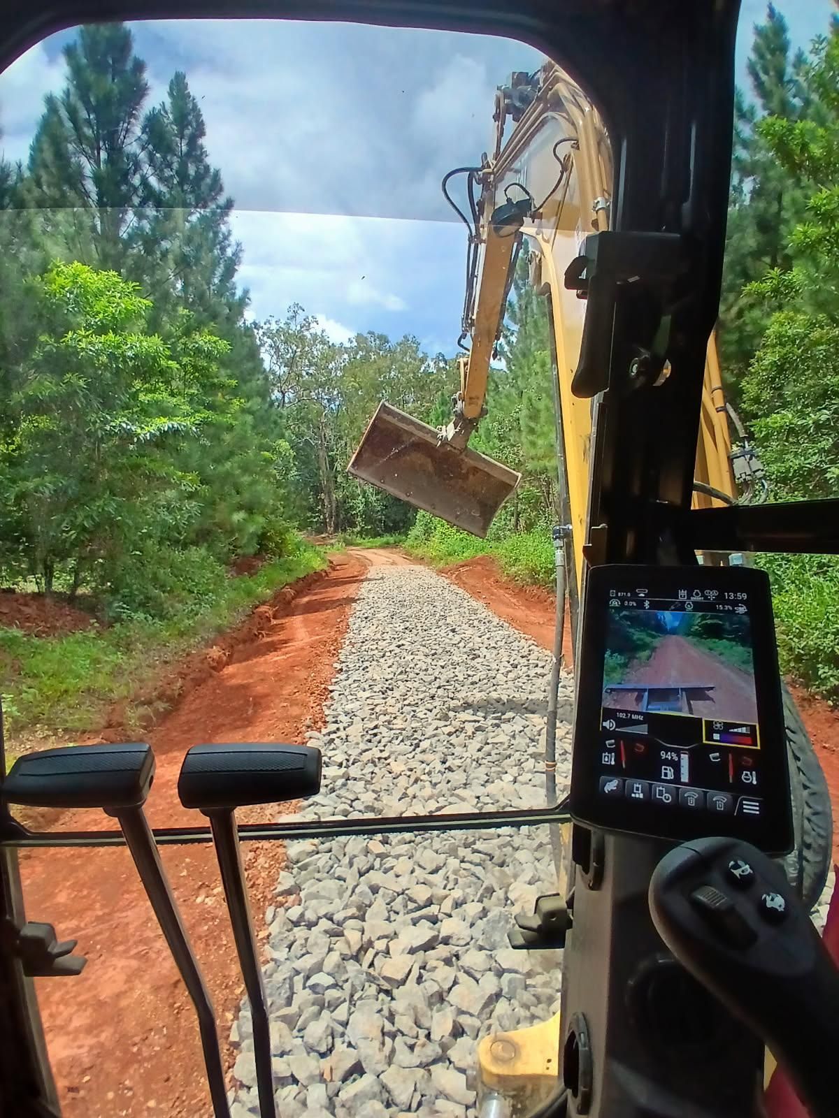 Yellow Construction Vehicles Parked by a Pile of Wood Chips — Kuranda Landscape Supplies in Kuranda, QLD