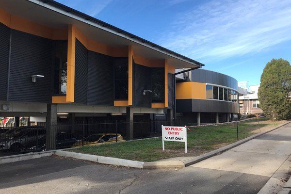 A large building with a no parking sign in front of it.