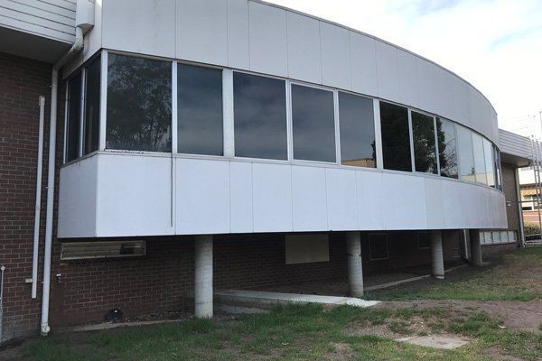 A large building with a lot of windows on the side of it.