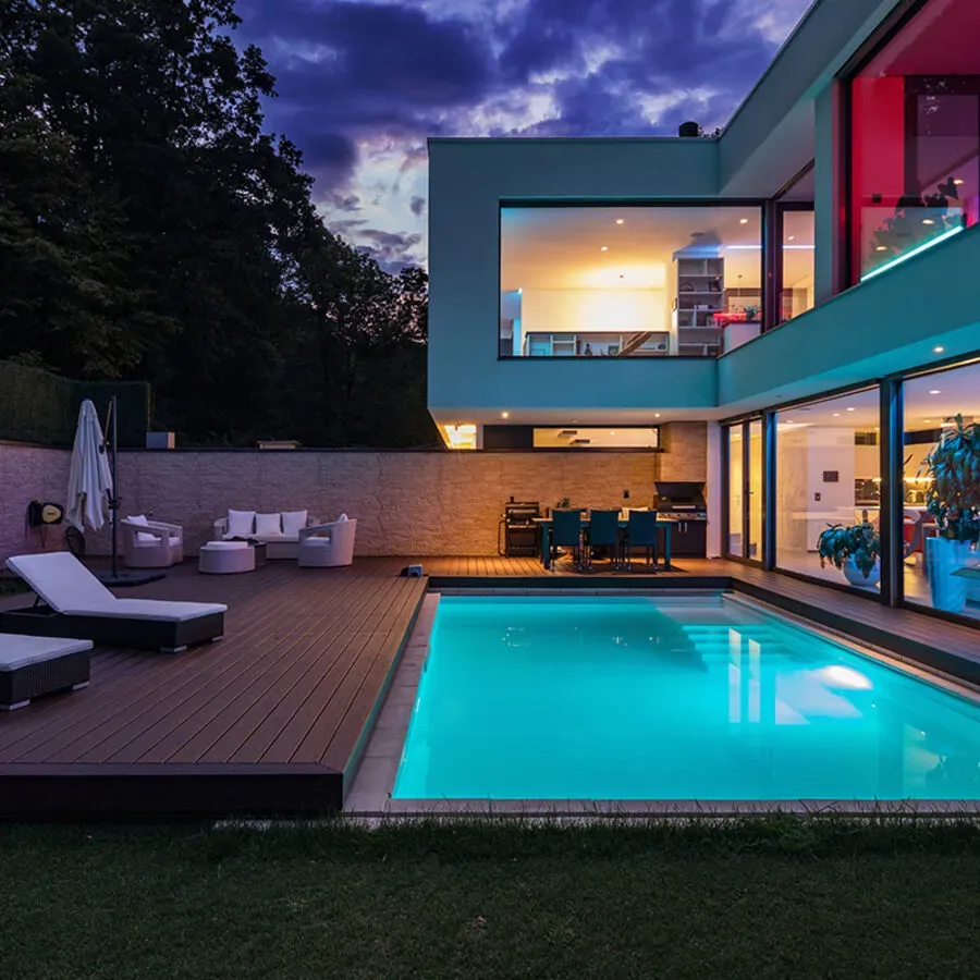 A large house with a large swimming pool in front of it