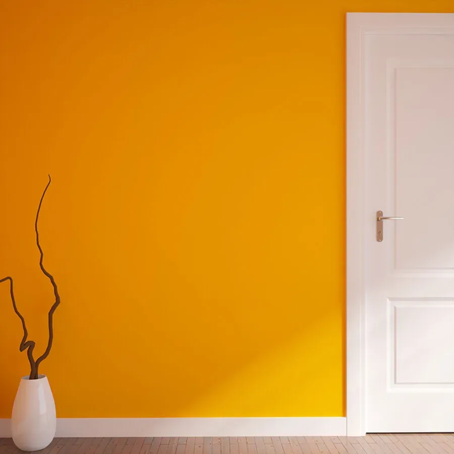A room with orange walls and a white door.