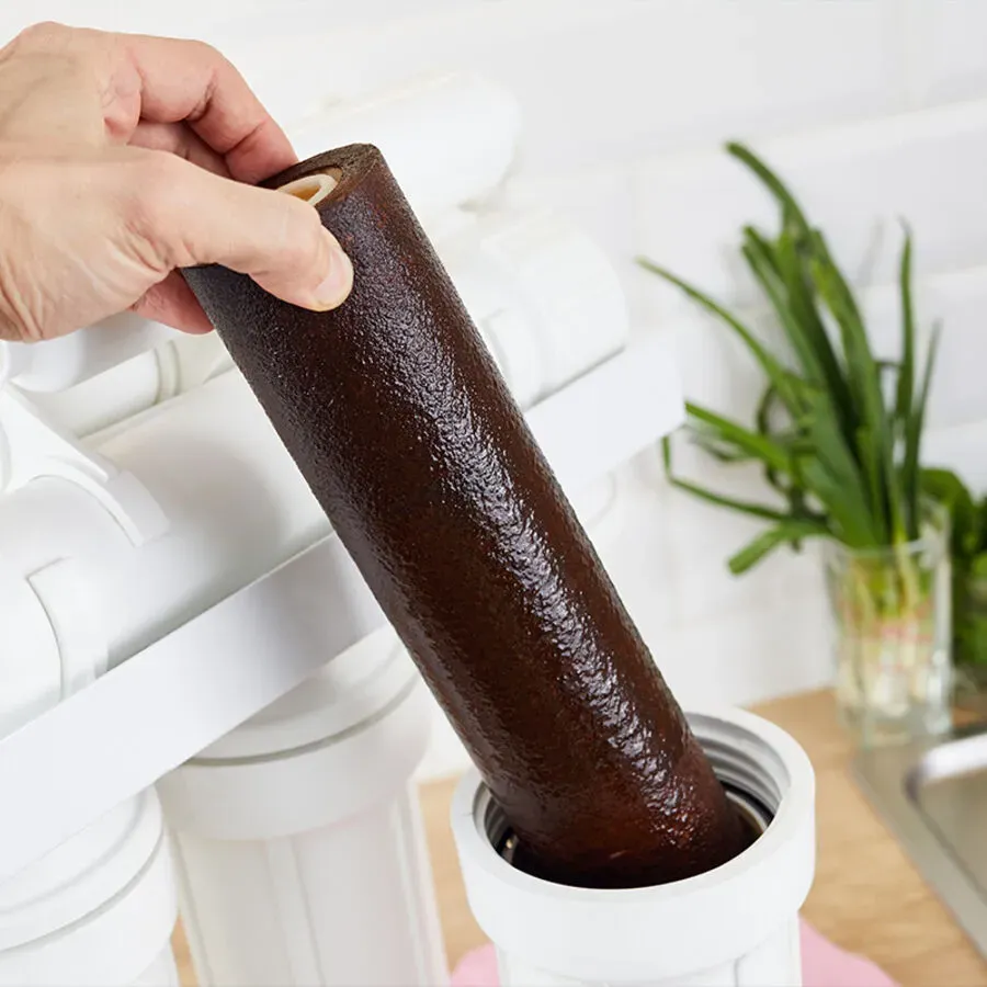 A person is holding a brown tube in their hand