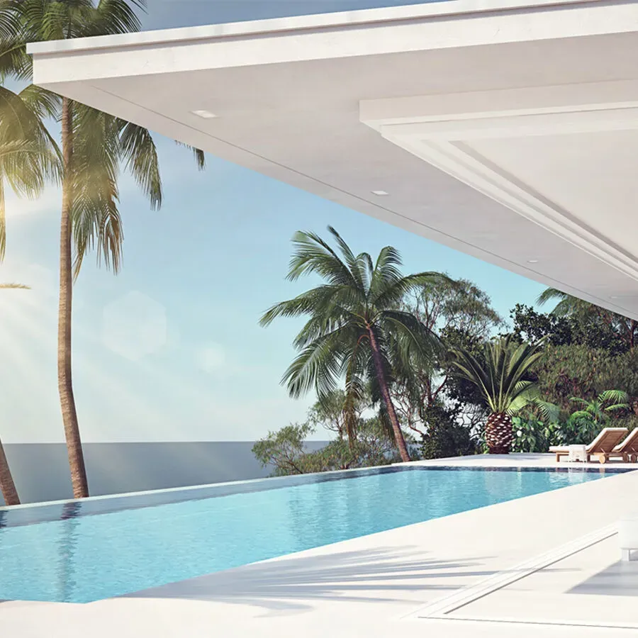 A swimming pool with a view of the ocean and palm trees