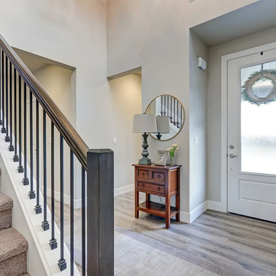 A staircase in a house with a mirror on the wall