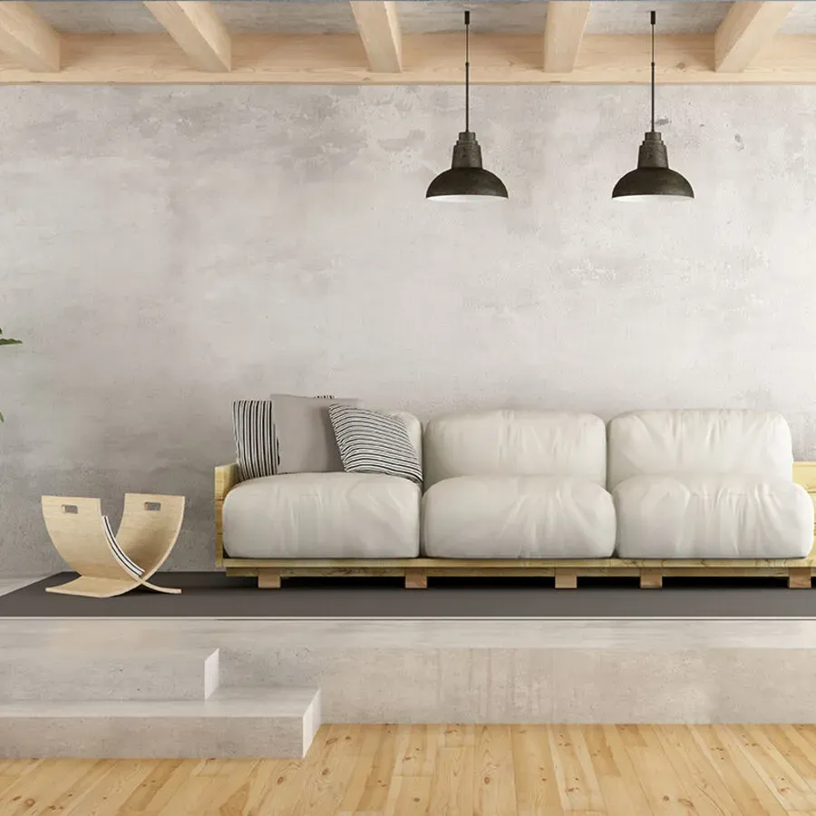 A living room with a white couch and wooden floors