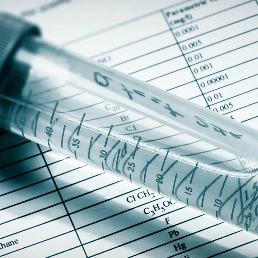 A pipette is sitting on top of a chemical table