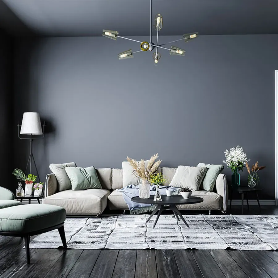 A living room with a couch , chairs , coffee table and rug.