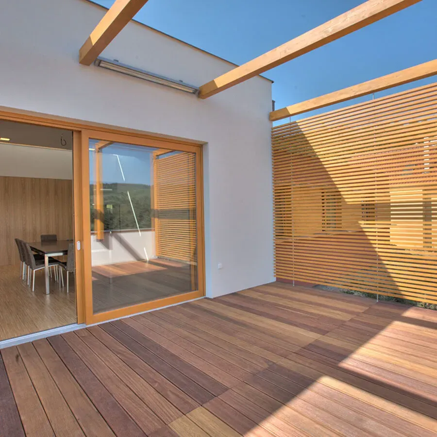 A wooden deck with a sliding glass door