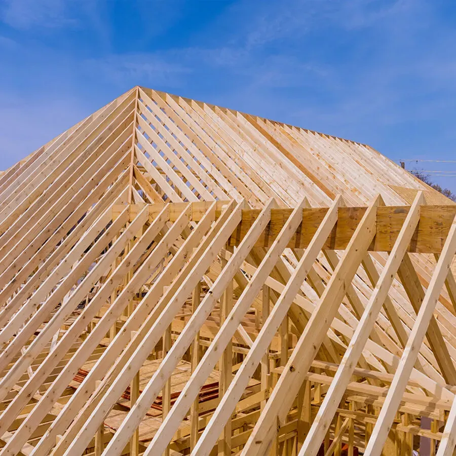 The roof of a house is being built with wooden beams