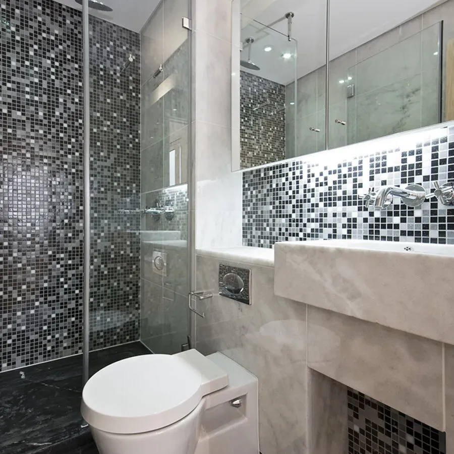 A bathroom with a toilet a sink and a shower