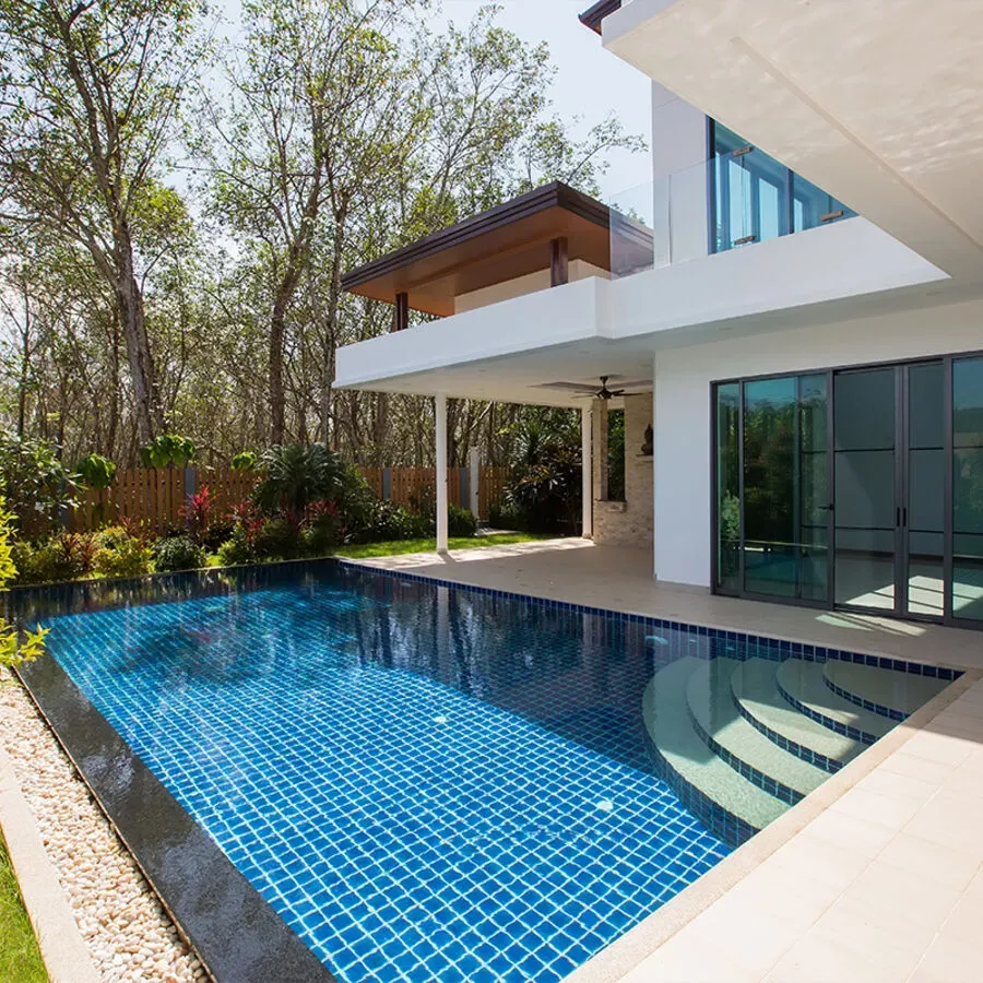 A large house with a large swimming pool in front of it