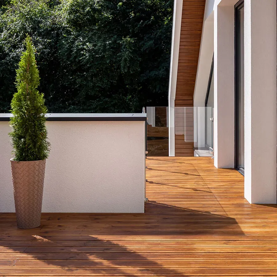 A wooden deck with a potted plant on it.