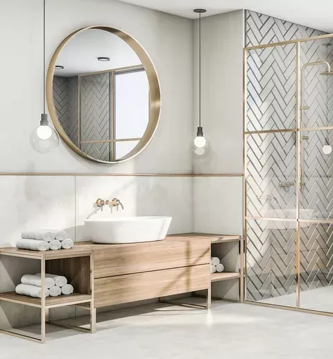 A bathroom with a sink , mirror and shower.