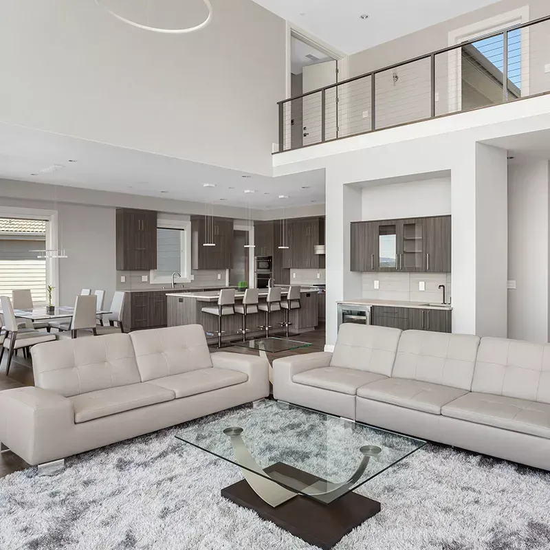 A living room with two couches and a glass coffee table