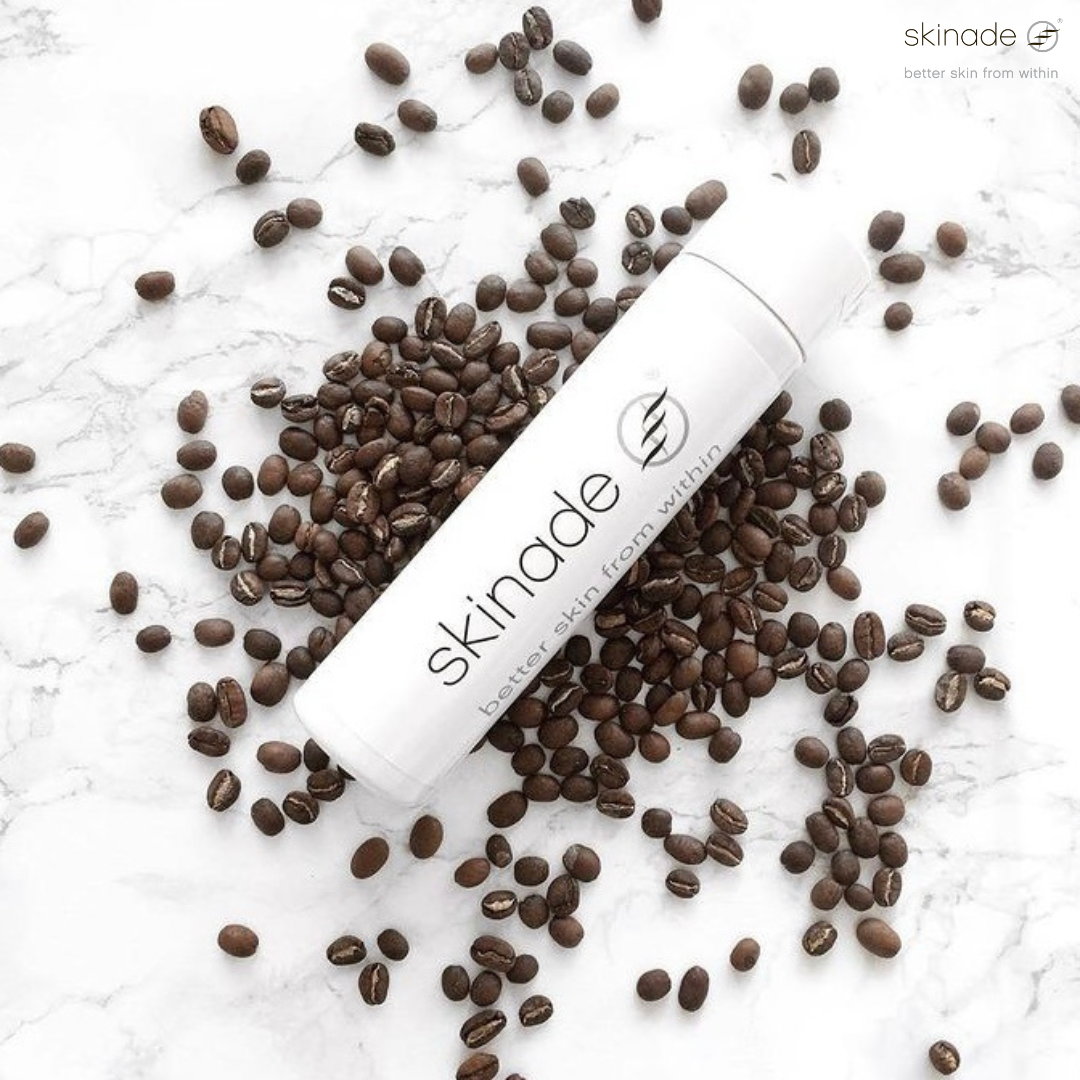 a bottle of skinade is surrounded by coffee beans