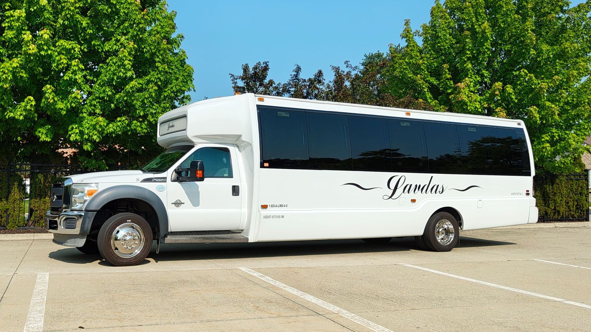 A white bus is parked in front of a church.