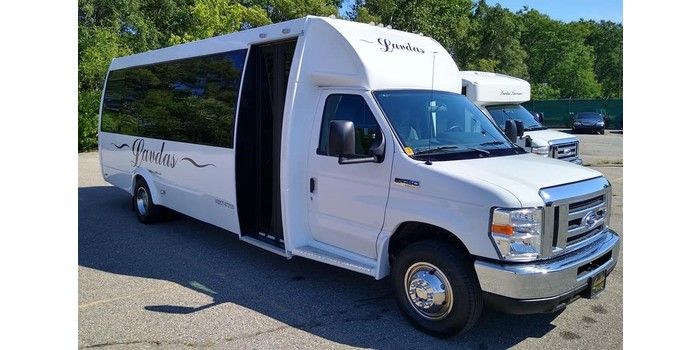 A white van is parked in a parking lot.
