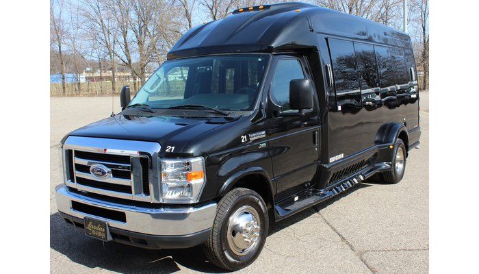 A black van is parked on the side of the road.